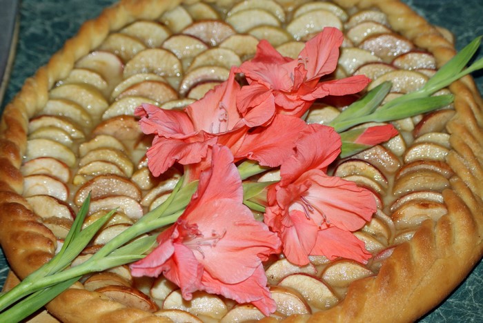 Apple pie with pink gladioluses