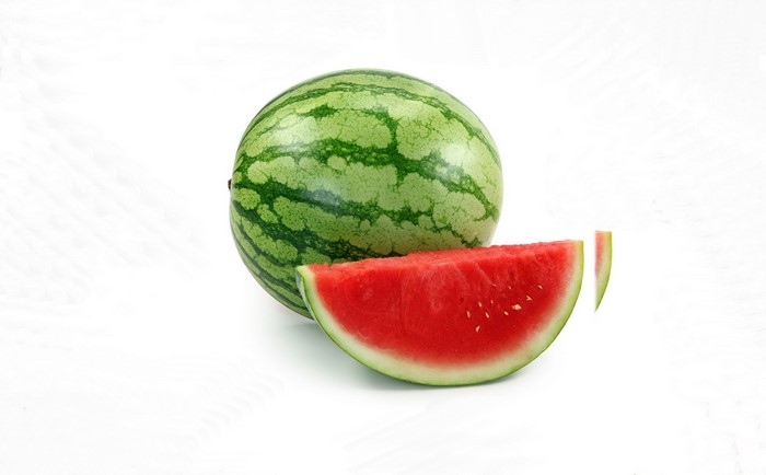 Whole watermelon with a slice and a small piece