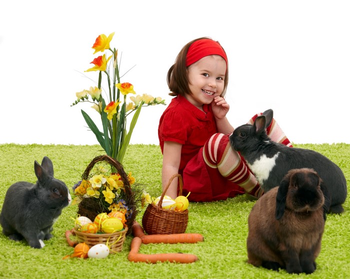 Girl with Hares and Easter Eggs on Grass