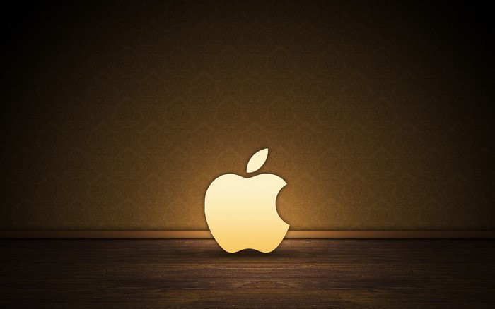 Golden Apple Logo on Textured Wall