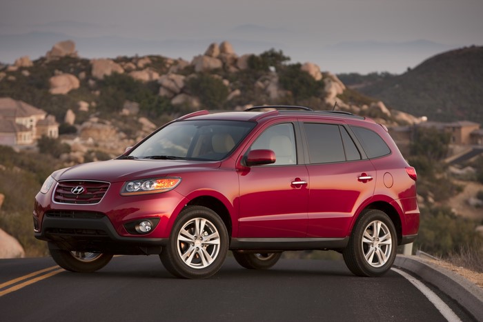 Red 2010 Hyundai Santa Fe on a road