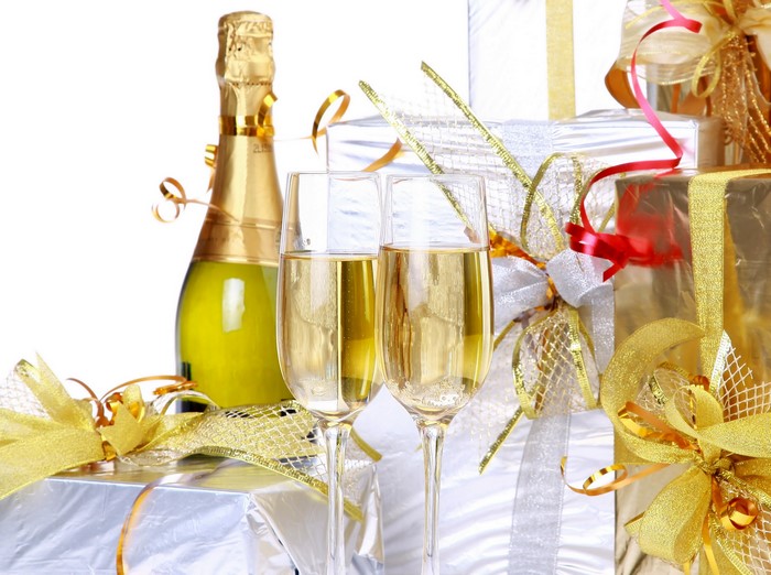 Champagne bottle and glasses with gifts
