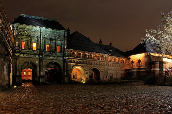 Old brick building with arched entrances at night