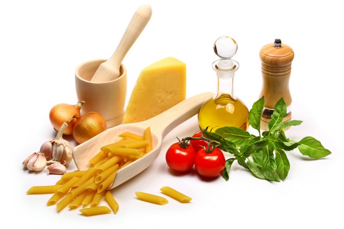 Still life of pasta, tomatoes, cheese, garlic, onions, olive oil, and basil