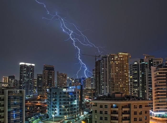 Lightning strikes over Dubai skyscrapers at night