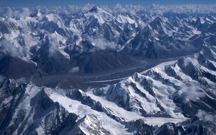 Snow-covered mountains and glaciers under a blue sky