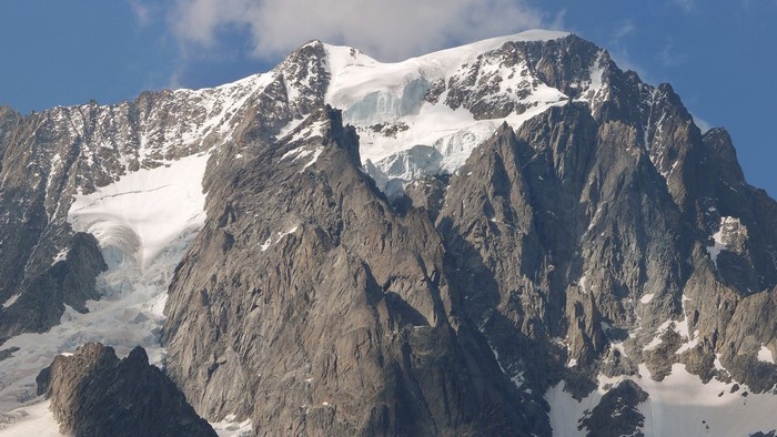 Snow-capped mountain range under a blue sky