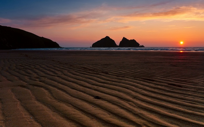 Beach at sunset with rocky islands