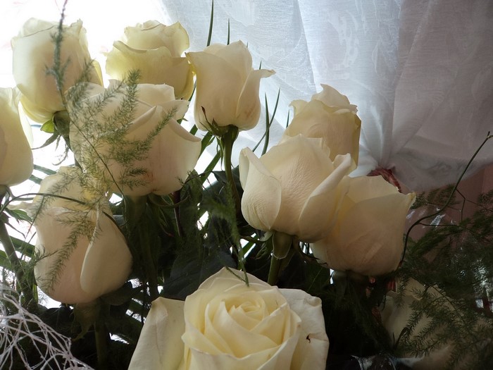Bouquet of white roses with greenery