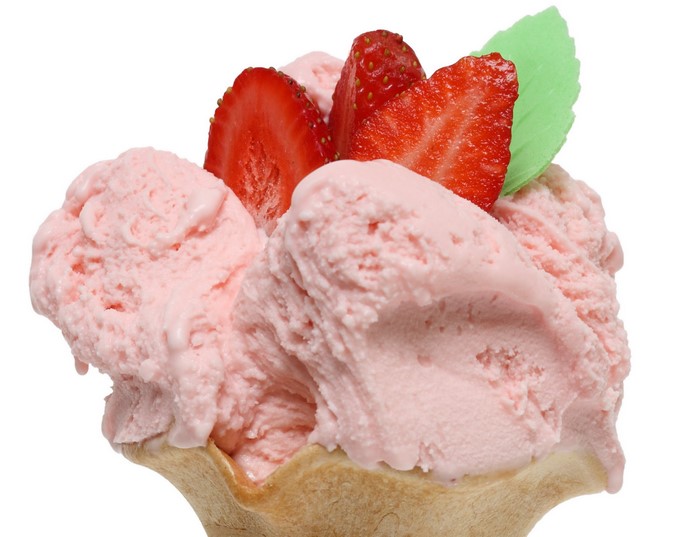 Strawberry ice cream in a cone with strawberries