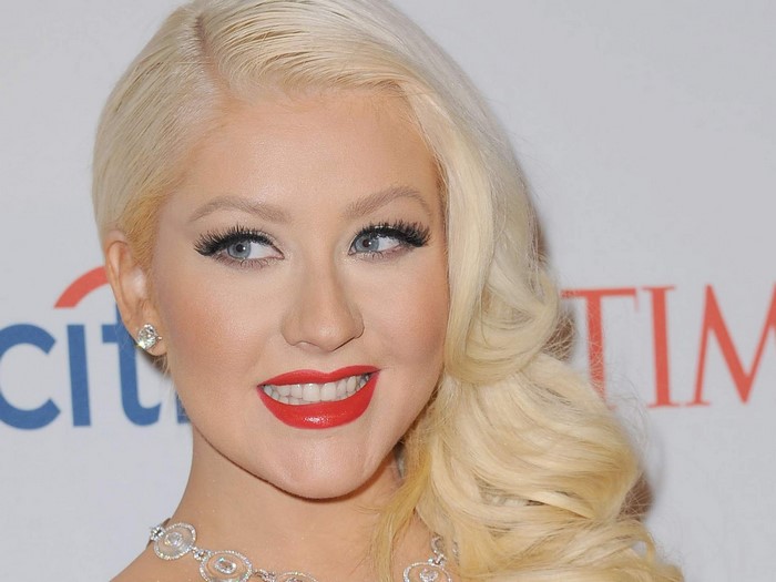 Christina Aguilera with blonde wavy hair and red lipstick