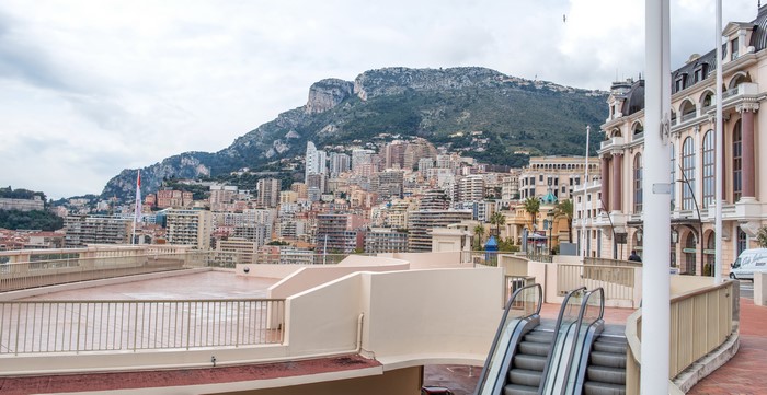 Monaco cityscape with mountains and escalators