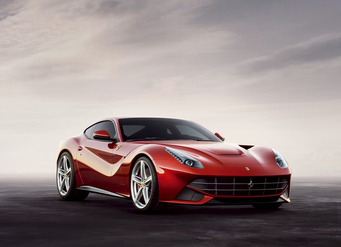 Red Ferrari F12berlinetta parked on dark surface