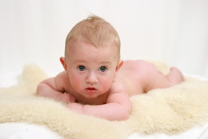 Baby lying on a fluffy rug