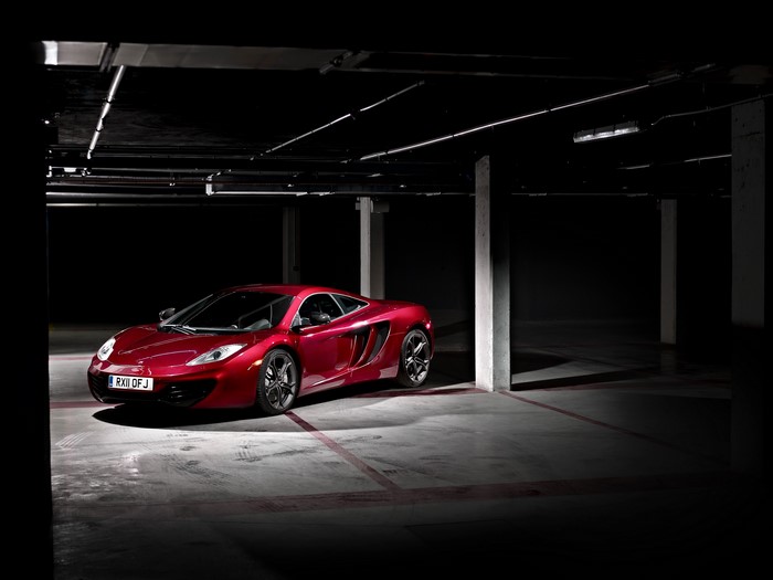 Red 2011 McLaren MP4-12C in parking garage