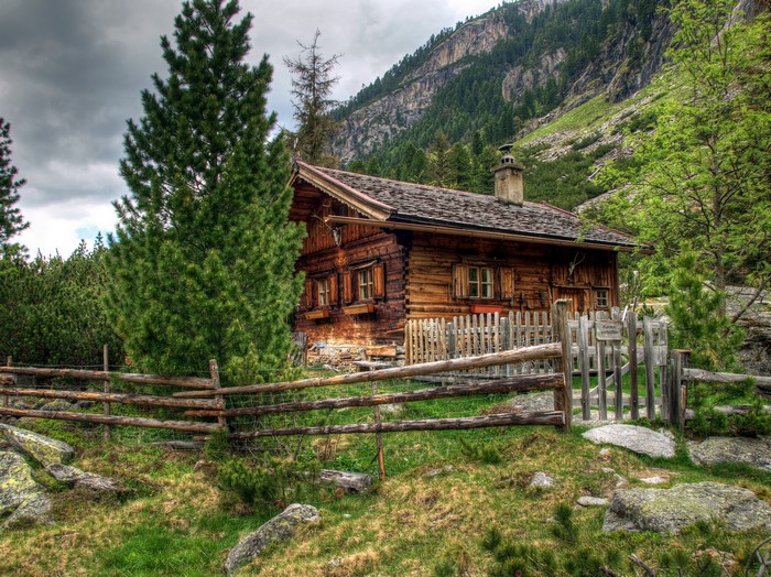Wooden cabin in the Austrian Alps with a fence