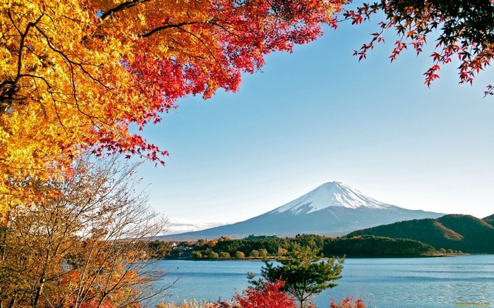 Mount Fuji and autumn leaves over a lake