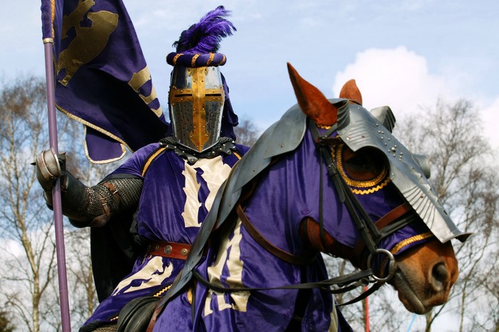 Knight in armor on a horse with a flag