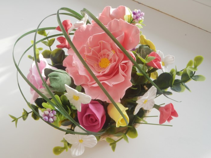 Artificial flower arrangement with pink roses and greenery