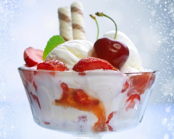 Ice cream sundae with strawberries and cherries