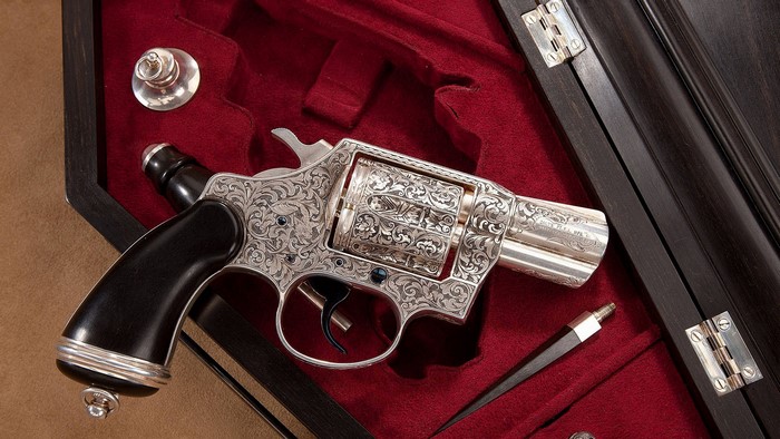 Engraved silver revolver in a wooden case