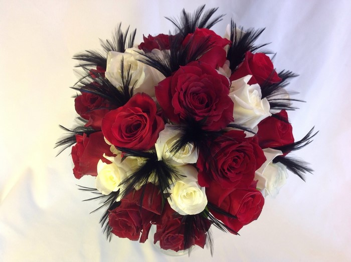 Red and white roses with black feathers bouquet