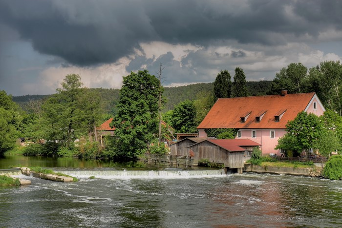 Mill building on a river in Regenstauf, Bavaria, Germany