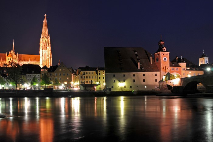 Regensburg skyline at night with illuminated cathedral and river