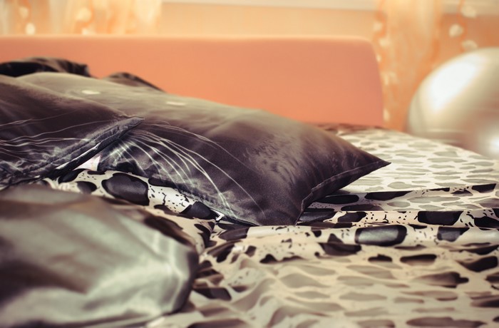 Black and white patterned pillows on a bed
