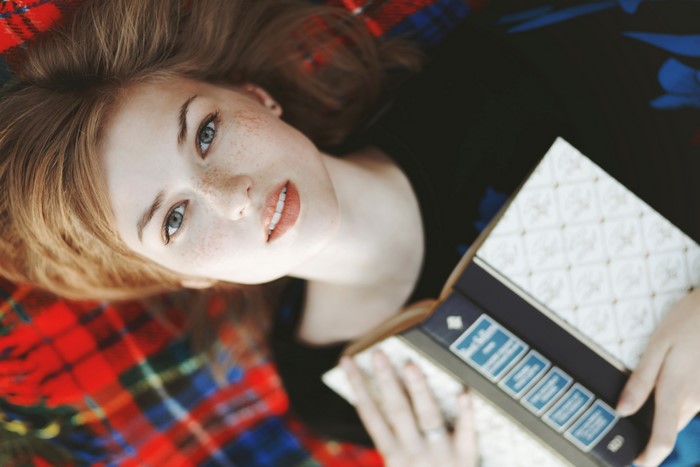 Woman with freckles reading a book