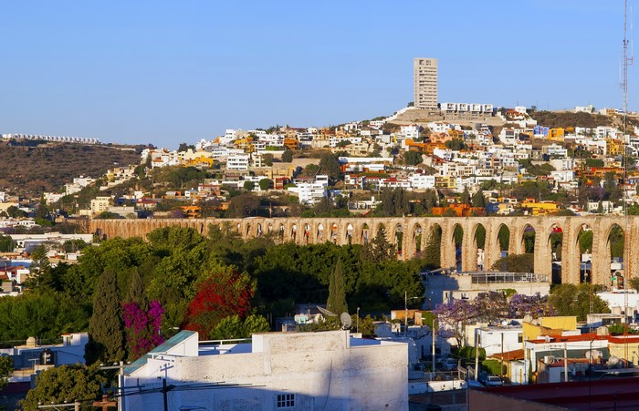 Aqueduct and city on a hill in Mexico