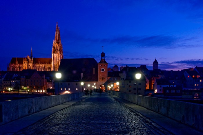 Stone bridge at night in Regensburg, Germany