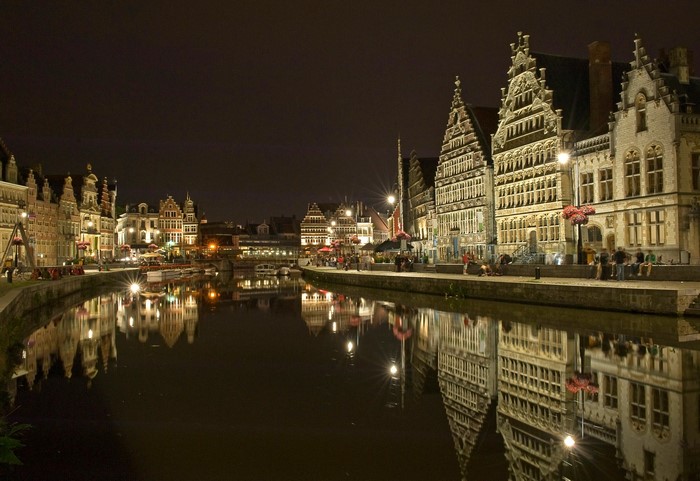 Ghent canal at night with historic houses and reflections