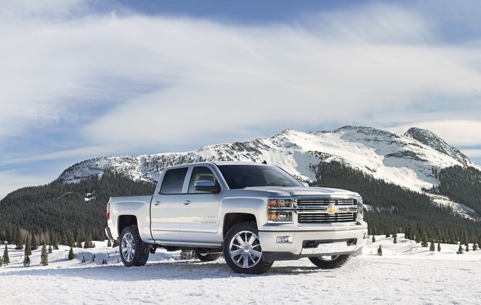 Silver Chevrolet Silverado truck in snowy mountains