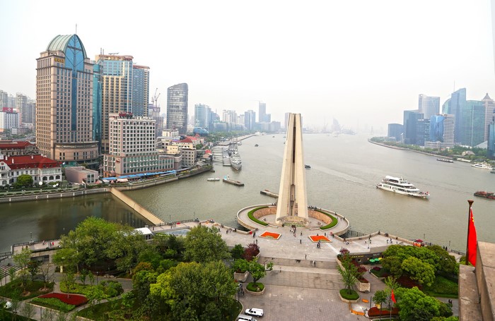 Shanghai Bund waterfront with monument and skyscrapers