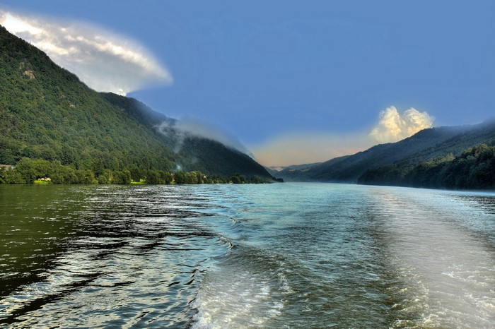 River landscape with mountains and clouds