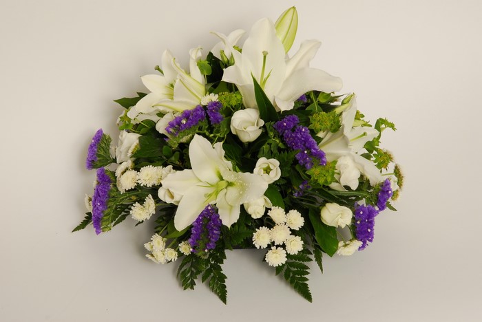 White lilies and purple statice flower arrangement