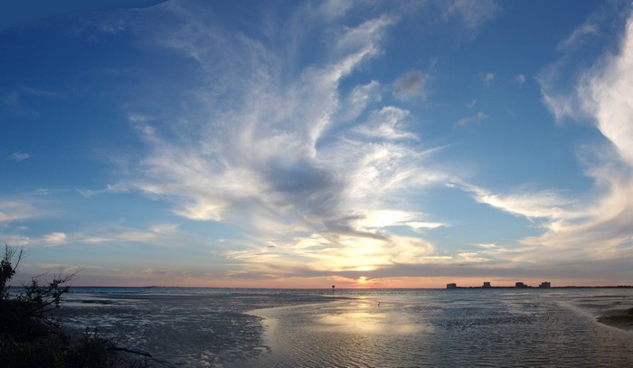 Sunset over the coast of Florida with scattered clouds