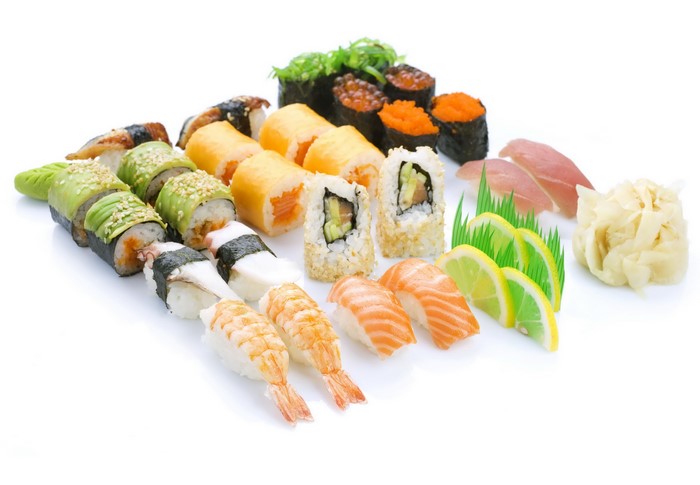 Assortment of sushi and sashimi on a white background