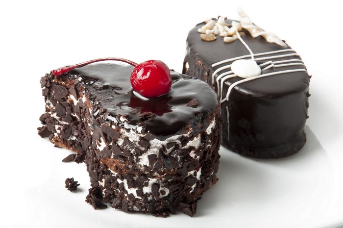 Two chocolate cakes with cherry and nuts