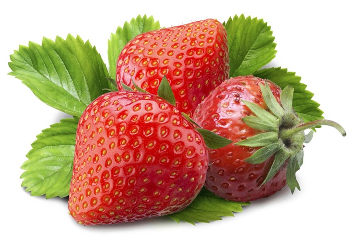 Three ripe strawberries with green leaves