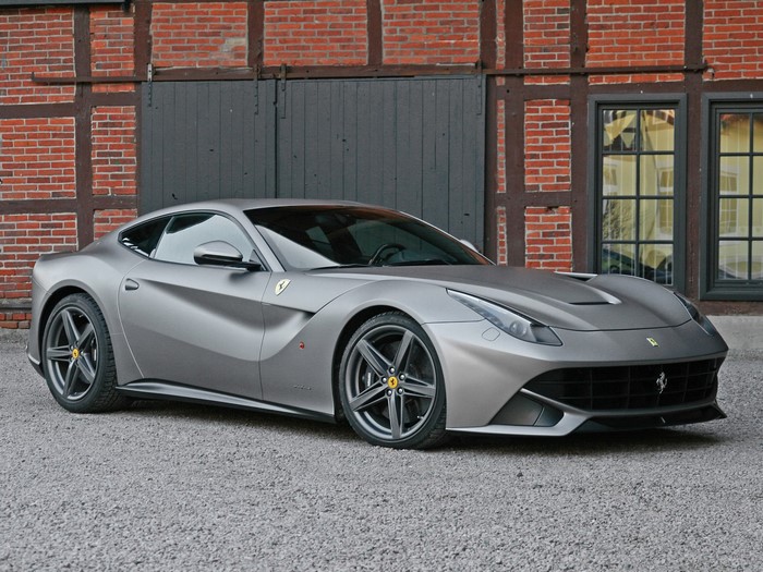 Matte Grey Ferrari F12berlinetta parked outside brick building