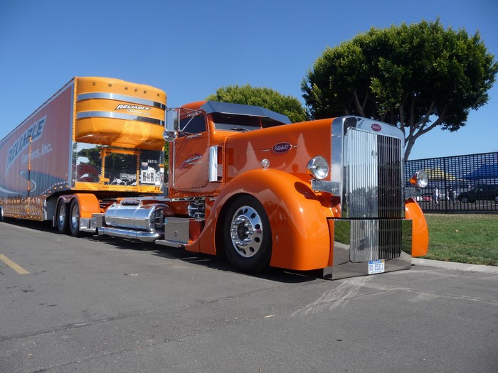 Orange Peterbilt Semi-Truck with Reliable Carriers Trailer
