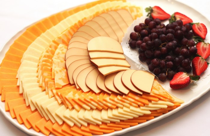 Cheese platter with grapes and strawberries