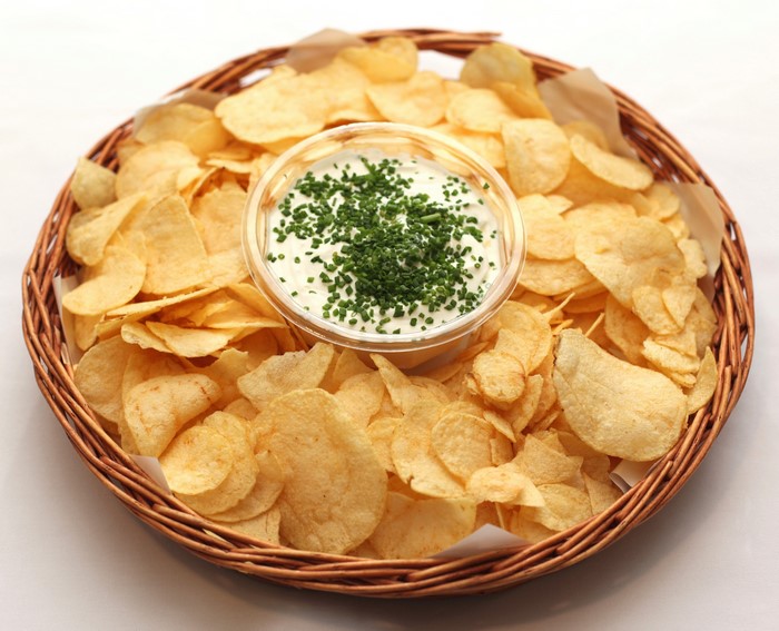 Basket of potato chips with dip