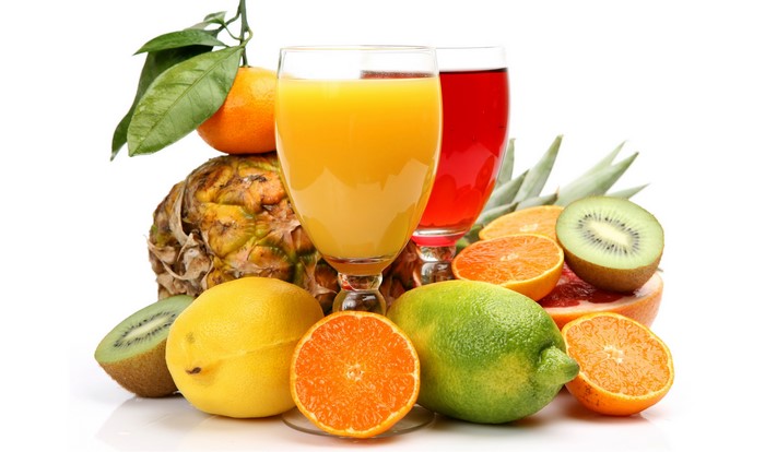 Assortment of fresh fruits and juices in glasses