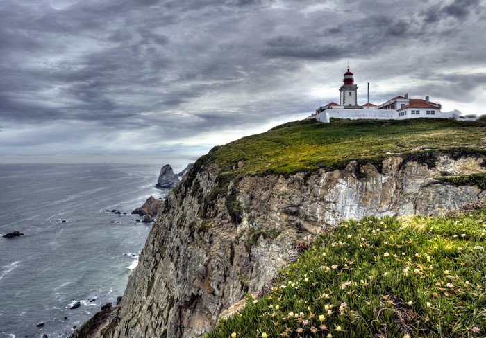 Lighthouse on a cliff overlooking the ocean in Portugal