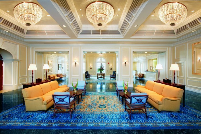 Luxurious hotel lobby with chandeliers and seating