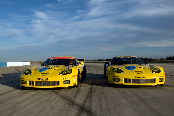 Two yellow Chevrolet Corvette C6-R GT2 race cars on a track