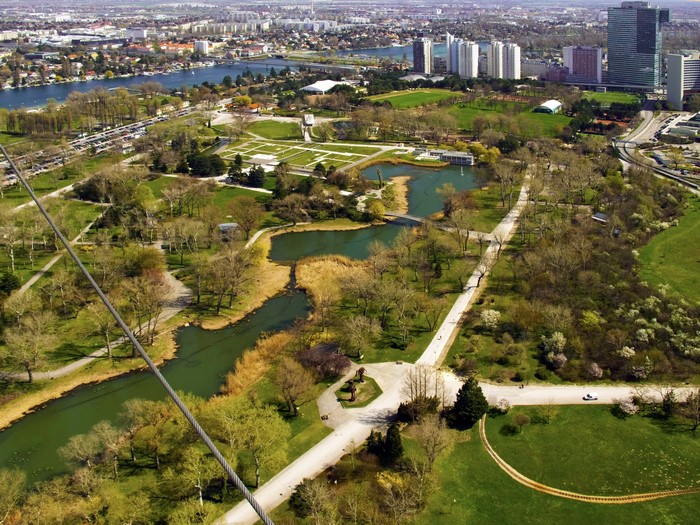 Vienna park with Danube Canal and city skyline